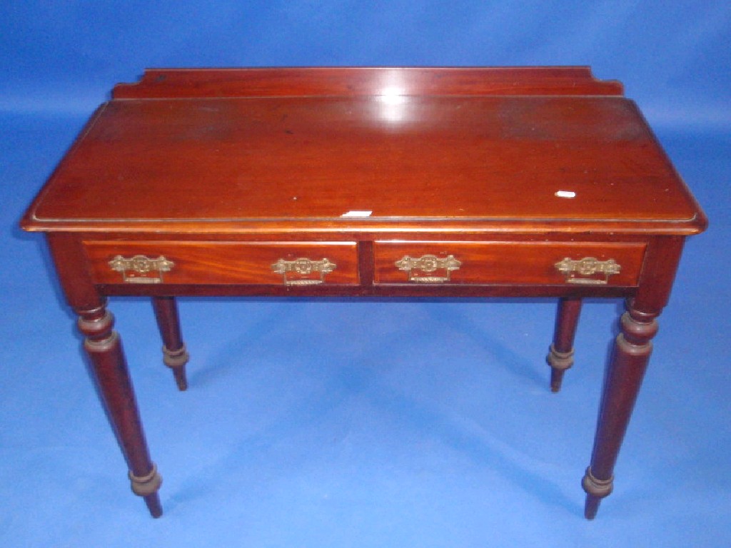 Appraisal: A Victorian mahogany side table with two drawers and turned