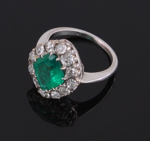 Appraisal: An emerald and diamond cluster ring the emerald of lozenge