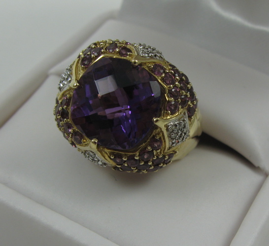 Appraisal: AMETHYST AND DIAMOND RING K yellow gold setting centering a