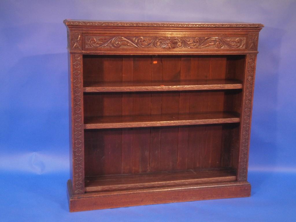 Appraisal: A thC oak open bookcase with carved foliate moulded edge