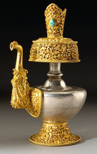 Appraisal: A Tibetan gilt copper alloy and silver kundika The silver