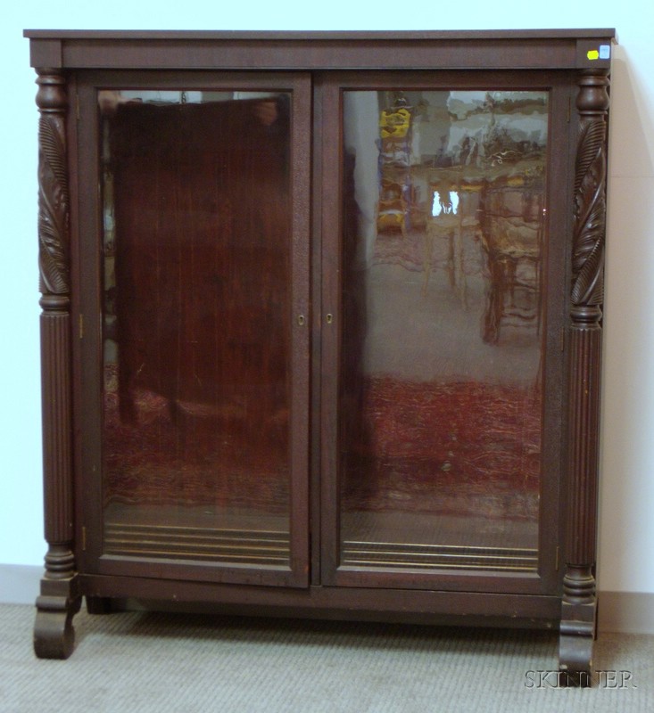 Appraisal: Empire-style Glazed Carved Mahogany Two-Door Bookcase with four adjustable shelves