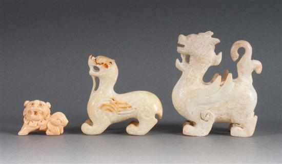 Appraisal: Three Chinese carved hardstone dragons and similar carved ivory foo