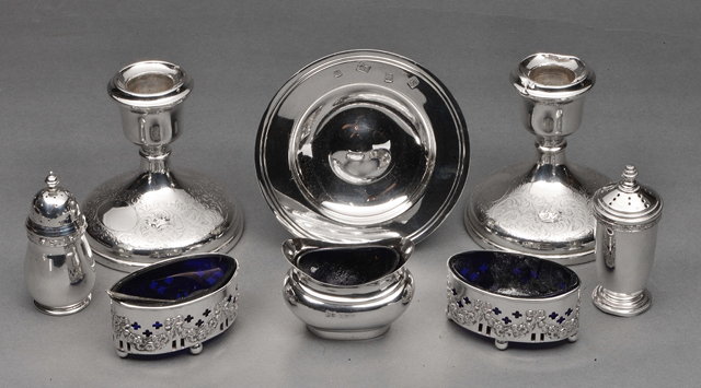 Appraisal: A PAIR OF SILVER DWARF CANDLESTICKS with engraved decoration five