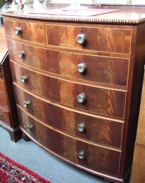 Appraisal: An early th century inlaid mahogany bowfront chest the top