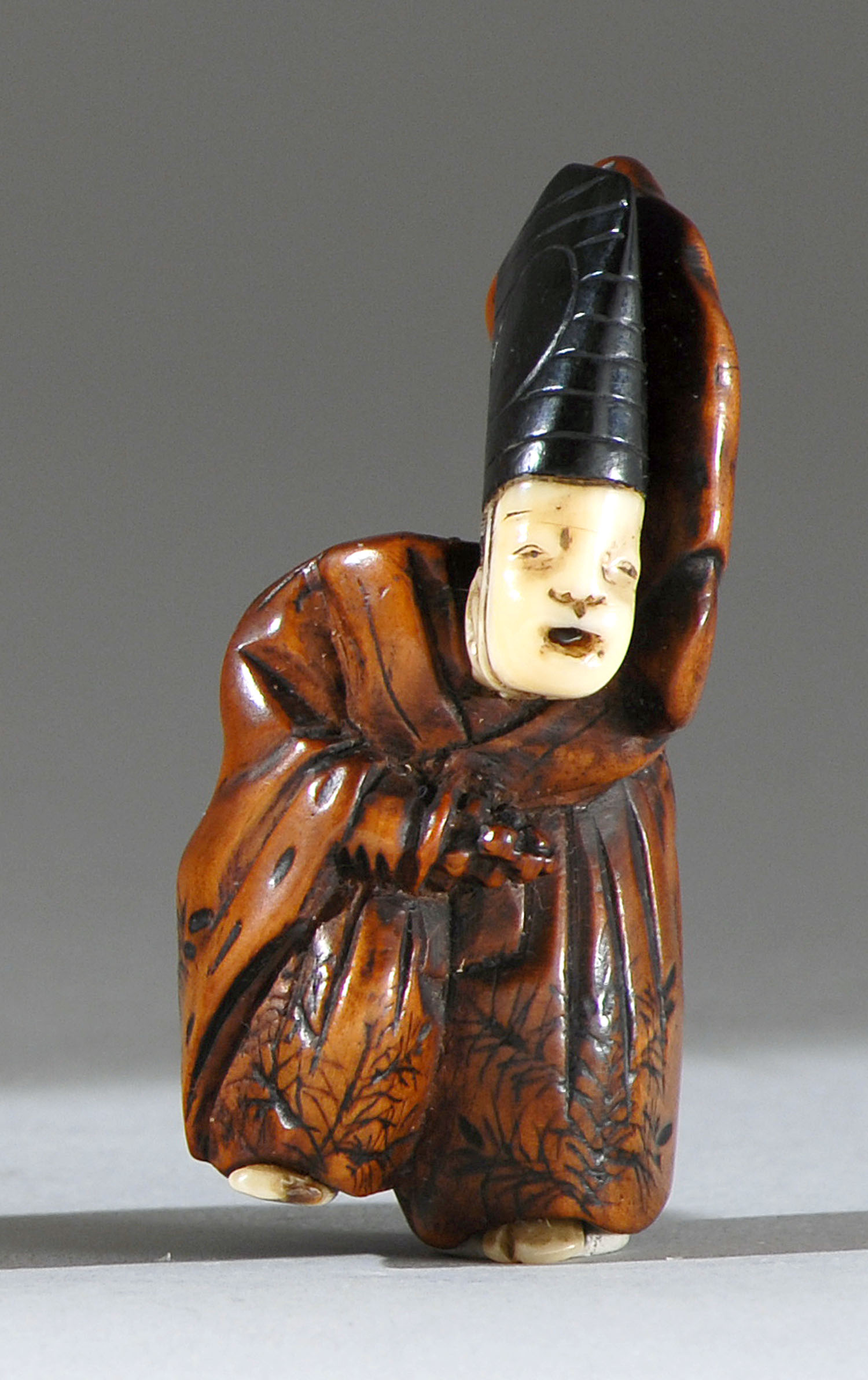 Appraisal: WOOD IVORY AND HORN NETSUKE th CenturyIn the form of