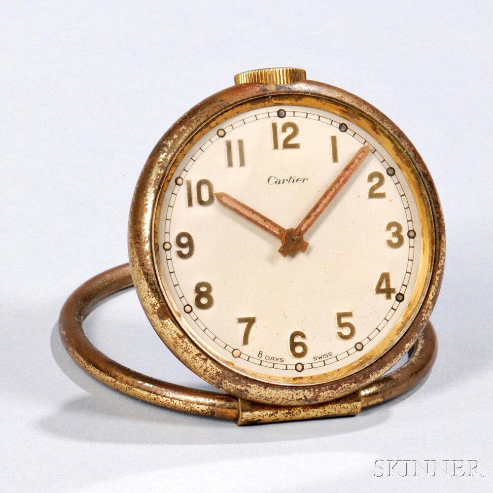 Appraisal: Cartier Travel Clock Switzerland brass pocket-watch-style clock with folding ring-shaped