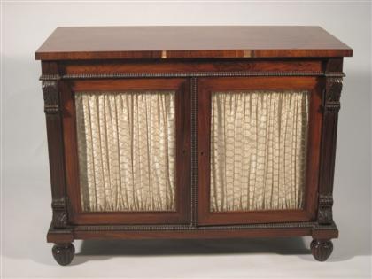 Appraisal: Regency style rosewood side cabinetThe rectangular top above a plain