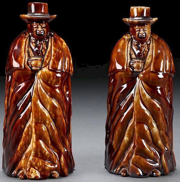 Appraisal: BENNINGTON GLAZED COACHMAN BOTTLES A PAIR OF BENNINGTON-ROCKINGHAM GLAZED COACHMAN