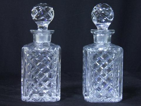 Appraisal: PAIR OF DIAMOND CUT DECANTERS STOPPPERS h in