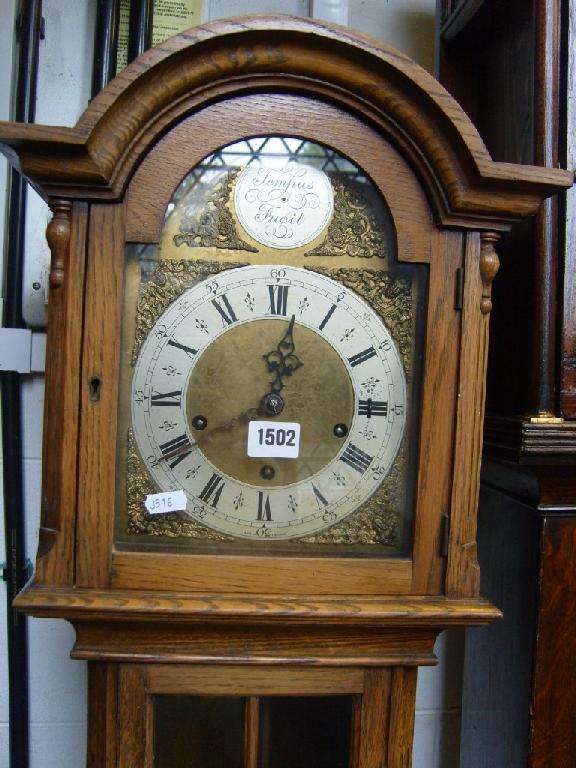 Appraisal: An oak cased grandmother clock with brass dial and silvered