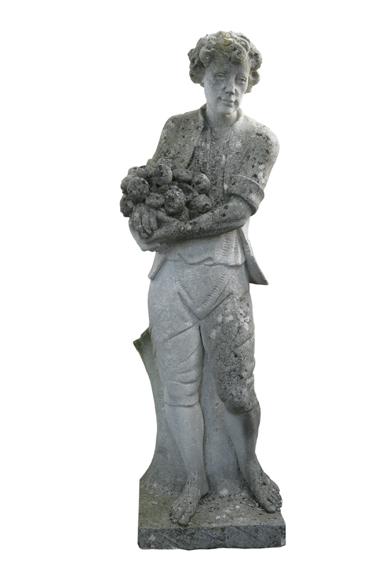 Appraisal: A CARVED STONE STATUE OF A YOUNG MAN holding fruit