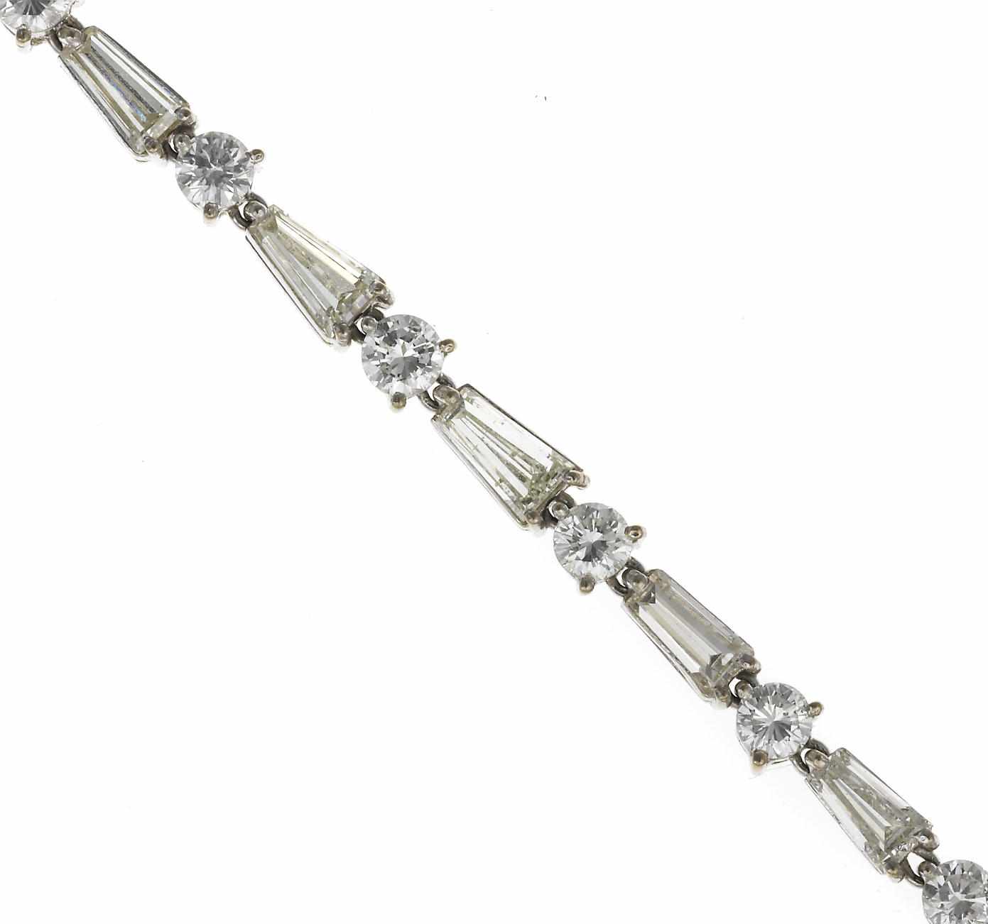 Appraisal: A diamond line bracelet composed of round brilliant and baguette-cut