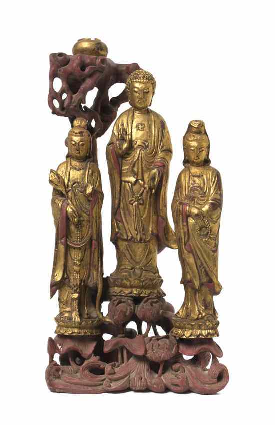 Appraisal: A Chinese Giltwood Model of the Buddhist Triad depicting the