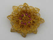 Appraisal: A yellow metal tests high carat gold filigree ruby brooch