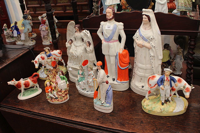 Appraisal: A PAIR OF STAFFORDSHIRE FLATBACK FIGURES of Queen Victoria and