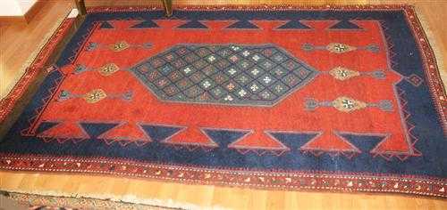 Appraisal: KAZAK old Red ground with a green medallion geometrically patterned