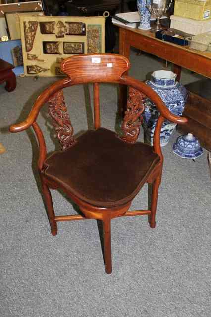 Appraisal: A CHINESE HARDWOOD CORNER CHAIR with carved dragon splats