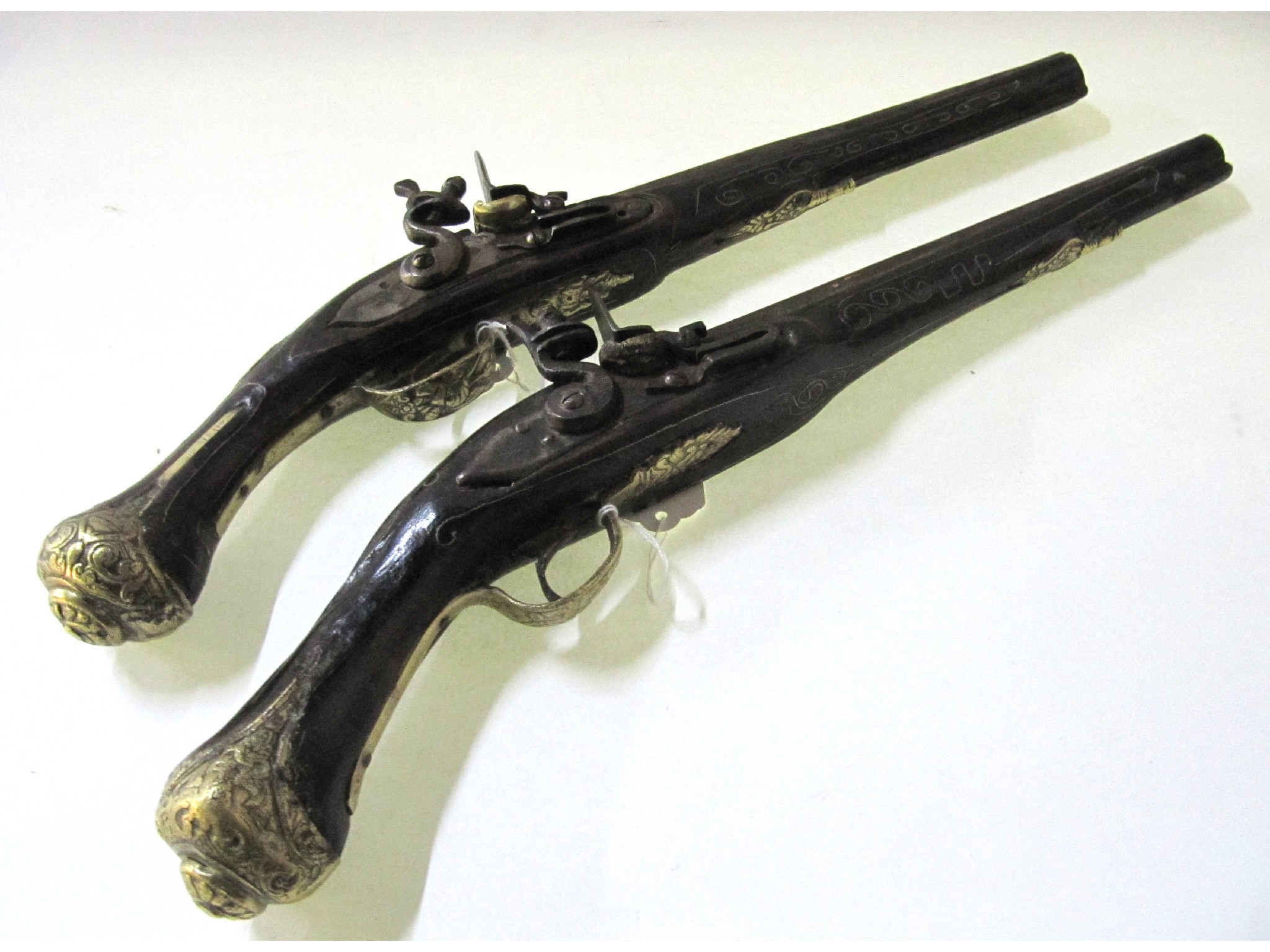 Appraisal: A lot comprising two Indian flintlock pistols