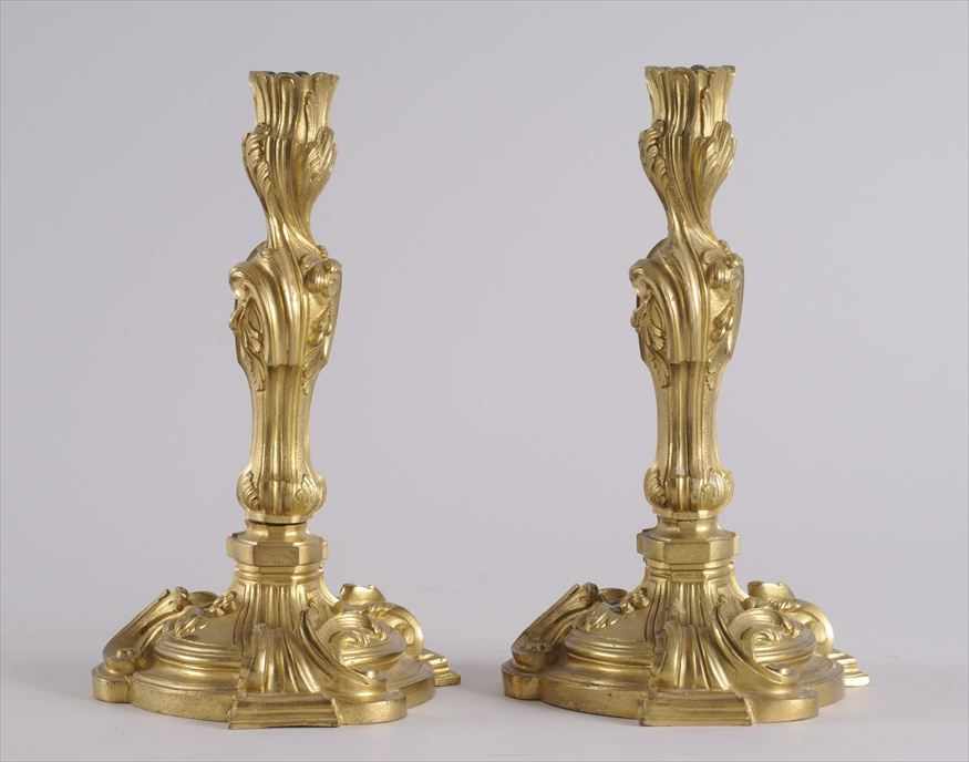 Appraisal: PAIR OF LOUIS XV STYLE GILT-BRONZE CANDLESTICKS Each baluster leaf-cast