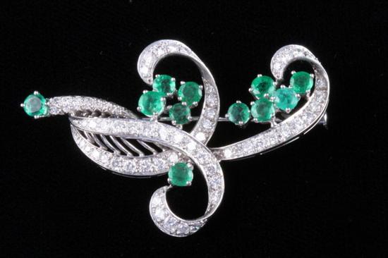 Appraisal: K WHITE GOLD EMERALD AND DIAMOND RIBBON MOTIF BROOCH diamonds