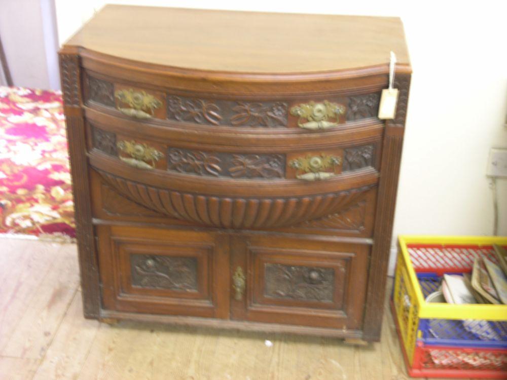 Appraisal: An Edwardian walnut serving table fitted with two bow fronted