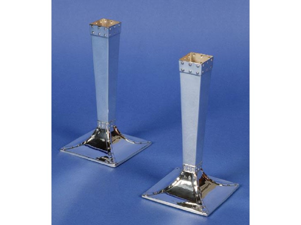 Appraisal: A PAIR OF GEORGE V CANDLESTICKS with tapering square columns