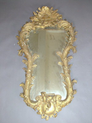 Appraisal: A giltwood and gesso shaped wall mirror the sunburst crest