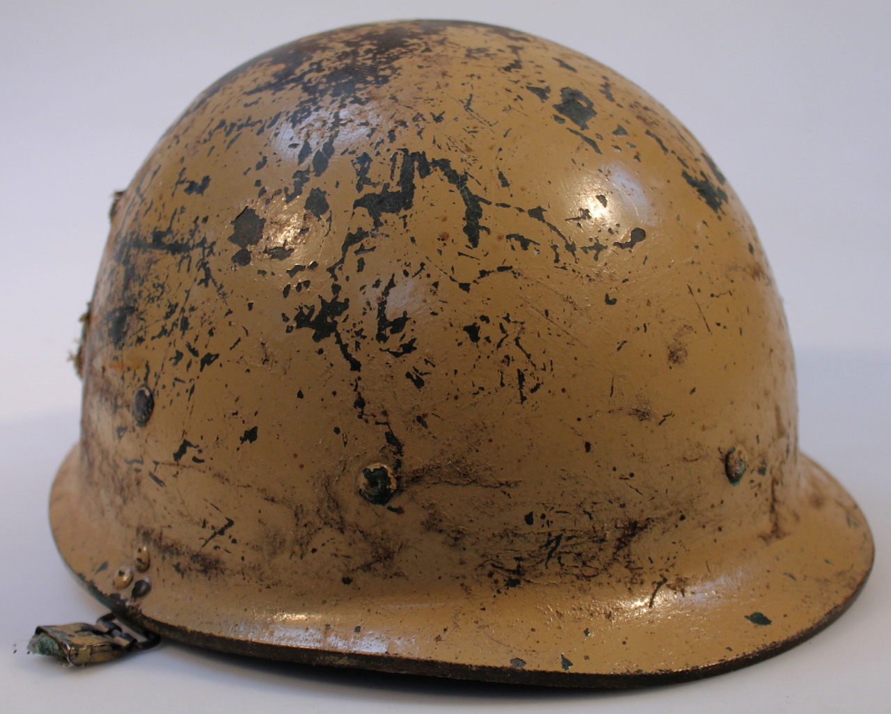 Appraisal: A thC painted war helmet in cream with a studded