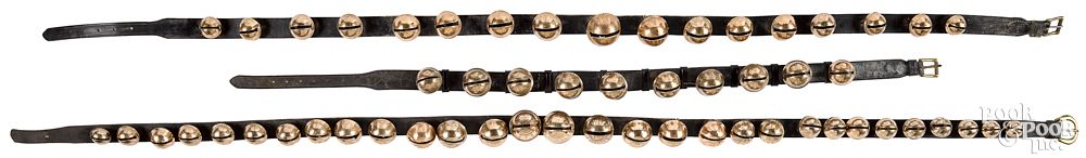 Appraisal: Three strands of brass sleigh bells longest - Three strands