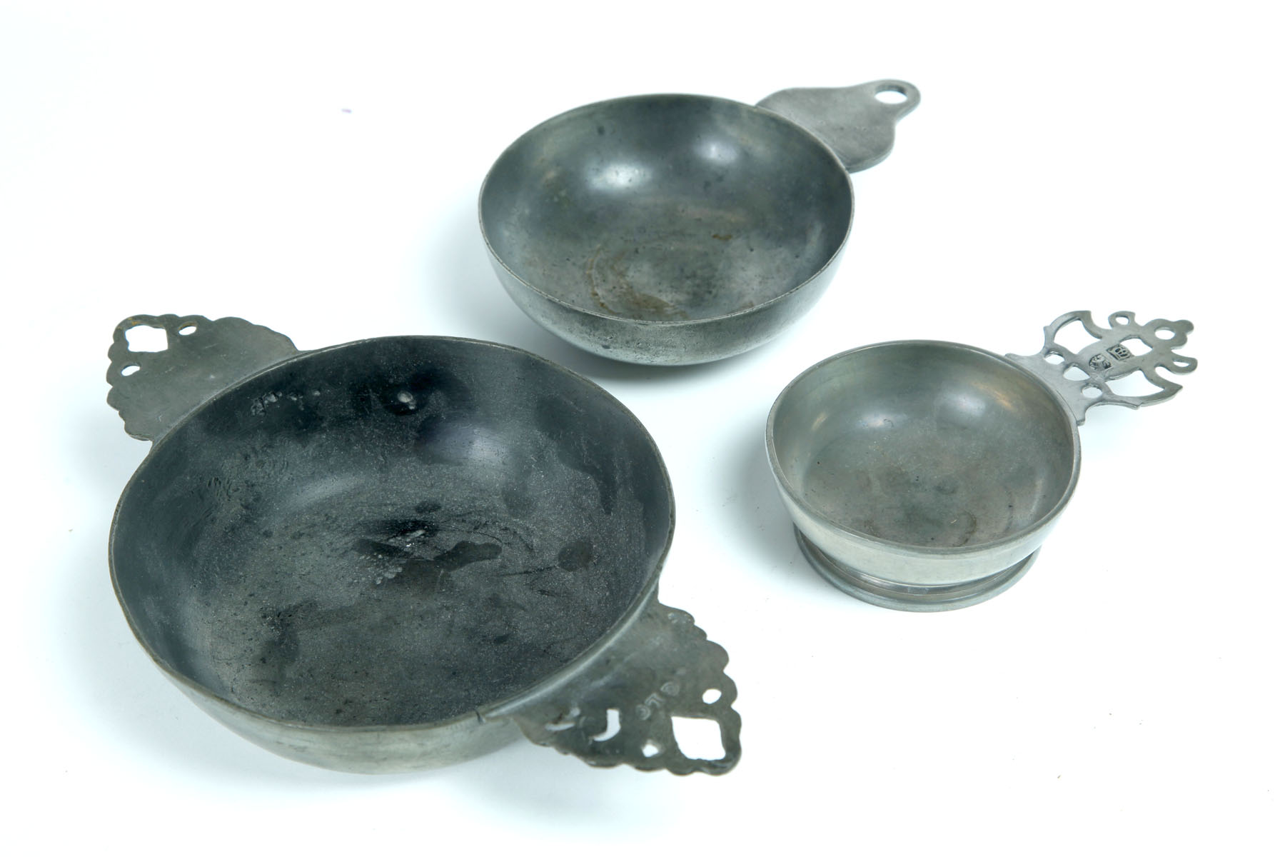 Appraisal: THREE PEWTER PORRINGERS American and English st half- th century