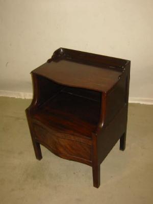 Appraisal: A GEORGE III MAHOGANY BEDSIDE CABINET of panelled serpentine form