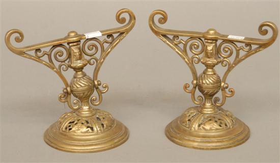 Appraisal: PAIR ANTIQUE BRONZE SUPPORTS Scrolled swivel tops with masks mounted