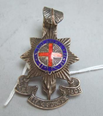 Appraisal: An officer's enameled cap badge of The Royal Sussex Regt