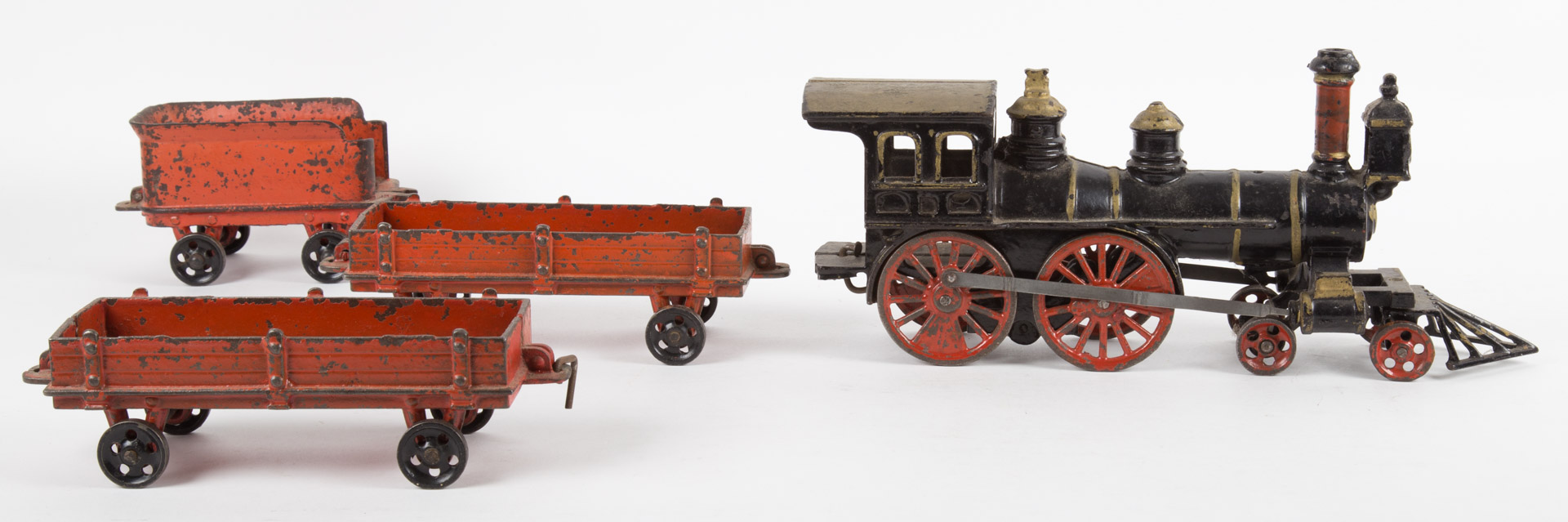 Appraisal: Early cast-iron engine tender and cars cast-iron E in engine