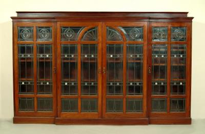 Appraisal: A LATE VICTORIAN MAHOGANY BOOKCASE of breakfront form with raised