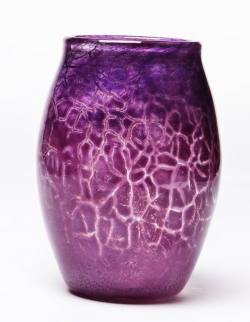 Appraisal: A MONART GLASS VASE with purple cracklure cased decoration concentric