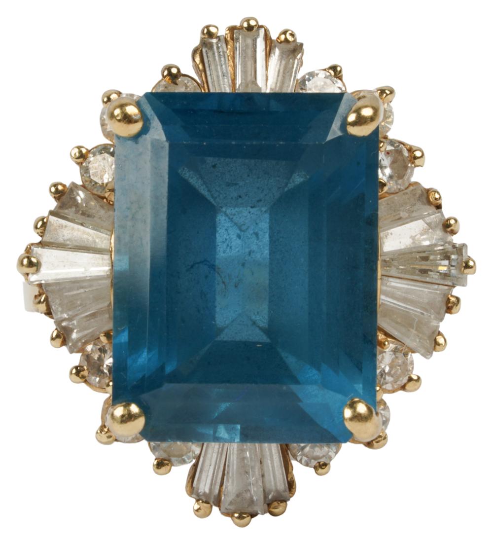 Appraisal: KARAT YELLOW GOLD BLUE TOPAZ DIAMOND RINGcentering one rectangular step