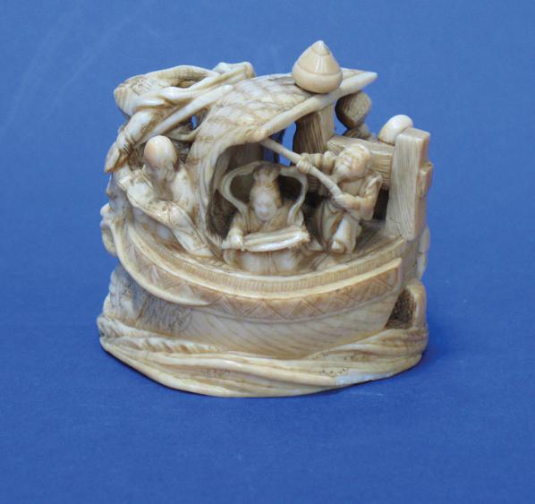 Appraisal: A JAPANESE IVORY OKIMONO of figures in a sailing boat