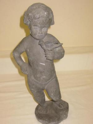 Appraisal: A LEAD FIGURE of a putto modelled standing and holding