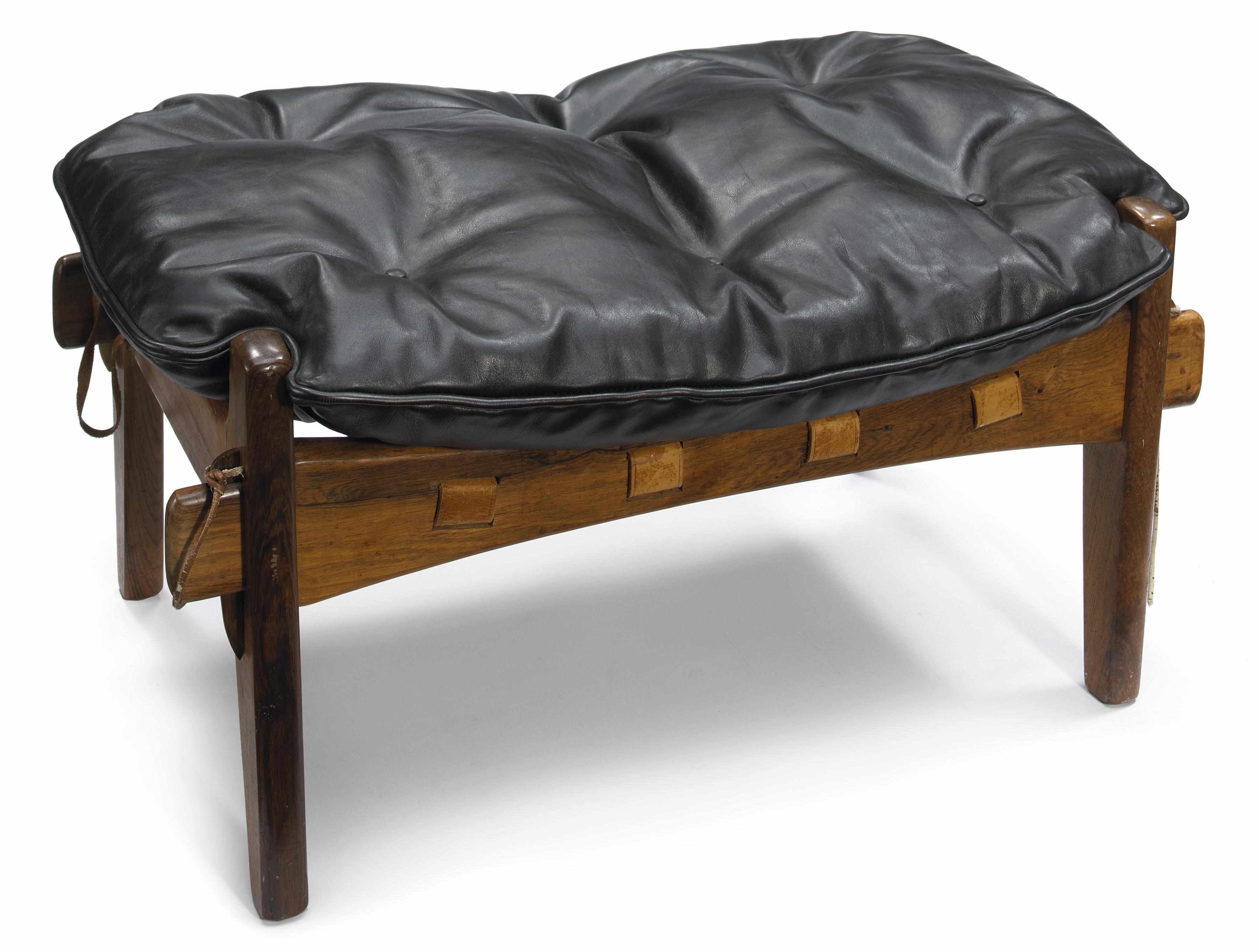 Appraisal: A Sergio Rodrigues rosewood and leather ottoman sre-covered in vintage