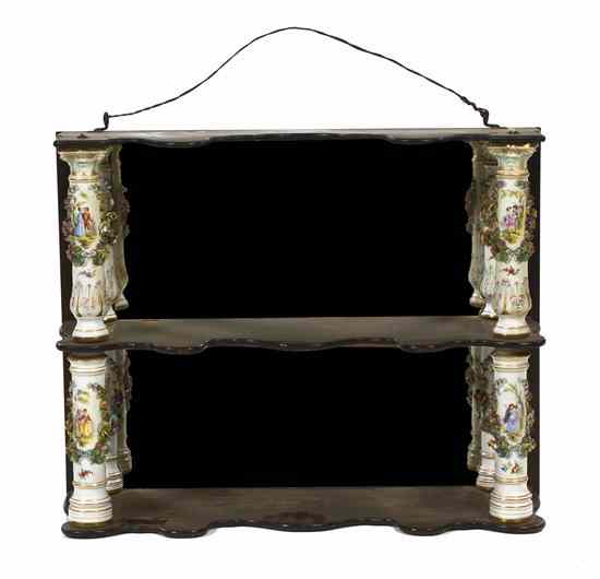 Appraisal: A German Porcelain Mounted Three-Tier Etagere the ebonized shelves joined