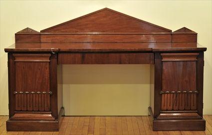 Appraisal: WILLIAM IV CARVED MAHOGANY PEDESTAL SIDEBOARD The rectangular top with