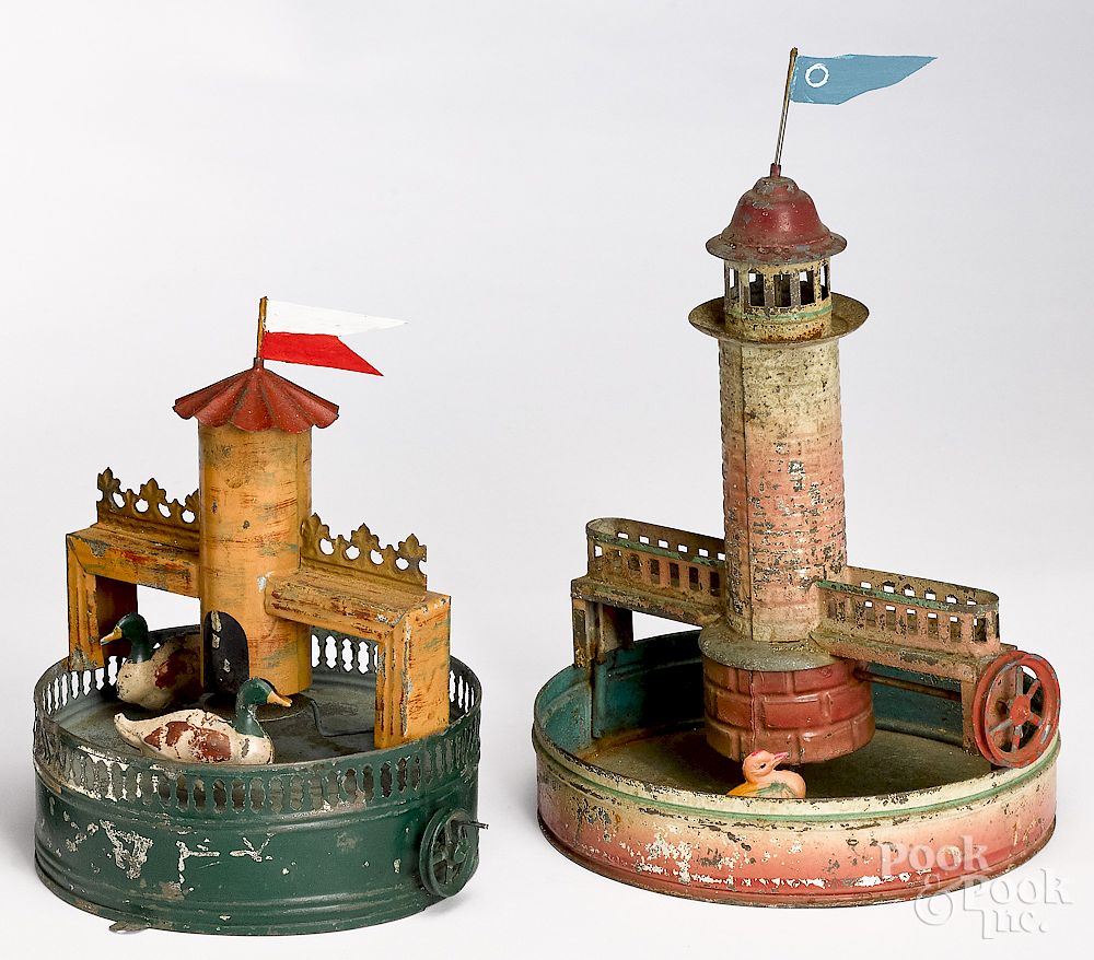 Appraisal: Two reservoir with lighthouse steam toy accessories Two painted tin