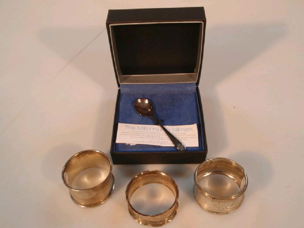 Appraisal: Three various napkin rings and a boxed presentation silver millennium