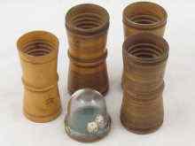 Appraisal: Four treen dice shakers cm long and a captive shaker