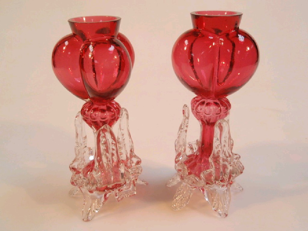 Appraisal: A pair of cranberry glass tri-lobe bulb vases with moulded