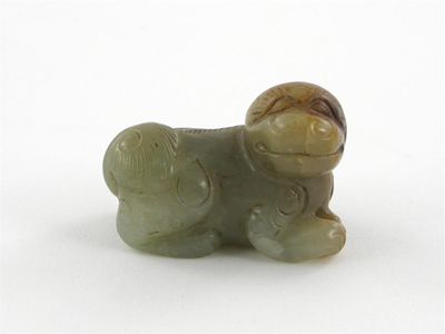 Appraisal: A small jade carving of a Buddhistic lion dog its