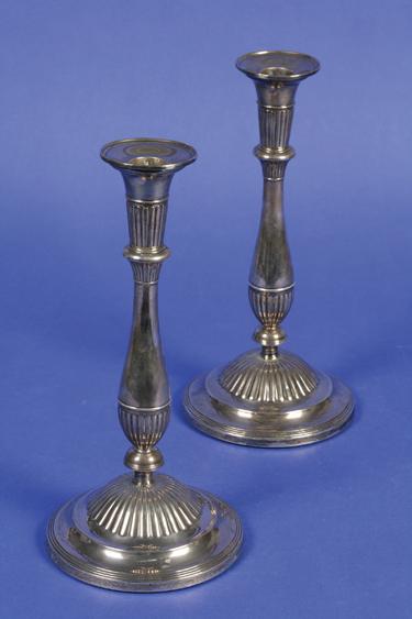 Appraisal: A PAIR OF GEORGE III CANDLESTICKS with waisted stems part-fluted