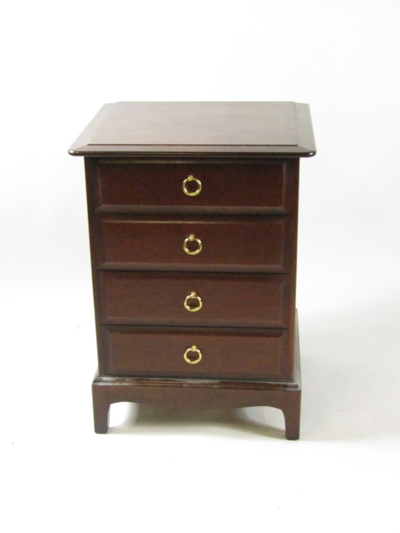 Appraisal: A Stag mahogany bedside chest of four drawers raised on